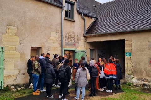 Groupe de visiteurs et visiteuses rentrant dans la petite salle d'exposition et de l'écomusée